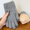 Detail view of grey knitted touchscreen gloves featuring warm fleece lining and stylish cuff tag. - One Size / Deer Label Double Fleece-Lined Style / Light Gray