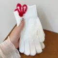 Detail view of winter warm knitted gloves for women with rabbit ears and touch-screen tips. - One Size / White