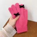 Detailed view of women's winter knit warm gloves in solid pink with chic black velvet bows. - One Size / Rose Red