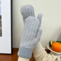 Grey fuzzy winter mittens detail showing soft plush texture and cozy ribbed cuff design. - Gray