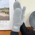 Close-up detail of soft fluffy grey winter mittens, cozy plush texture and ribbed cuff design. - One Size / Gray