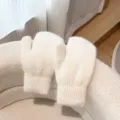 Cozy white fluffy knit mittens detail, soft warm winter plush gloves close-up view - Cream