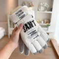 Detailed view of thick winter ski gloves with letter print, windproof and thermal design. - Non-Slip / Adjustable / Water-Repellent / White