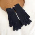 Close-up detail of black knitted winter gloves, showing ribbed texture and soft warm fabric. - One Size / Black