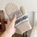 Detail shot of thick warm winter knitted mittens with classic snowflake and mountain Nordic patterns. - One Size / Beige
