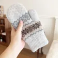 Detailed view of winter warm knitted mittens, thick fleece-lined snowflake pattern design. - One Size / Light Gray