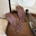 Detail view of women's velvet gloves featuring elegant bowknot and lace trim for cold weather. - One Size / Purple