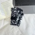 Fuzzy black and white leopard print fingerless gloves close up, cozy winter warm knit wear. - One Size / Black