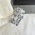 Close-up detail of fluffy leopard print fingerless winter gloves with cute bow decoration. - One Size / Gray