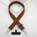 Vista dettagliata della tracolla per telefono marrone intrecciata con dettagli dorati e linguetta. - Pad Stile T / Marrone scuro