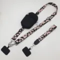 Detailed view of the universal phone lanyard with zipper pouch and adjustable leopard strap. - Vertical Pouch / Silver Hook & Gasket Ring / Black Pink & Black Pouch