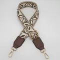 Tracolla di ricambio larga in jacquard regolabile con pelle PU e minuteria metallica dorata. - Base Beige Kaki Scuro con Pelle Kaki Scuro