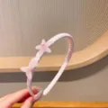 Serre-tête rose pour enfants avec décorations d'étoiles et de nœuds, accessoire confortable. - Bandeau Étoile de Mer Rose