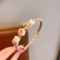 Detail view of cute brown plaid children hair hoop with sweet bear and strawberry charms. - Brown Bear Cake
