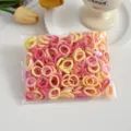 Detailed view of colorful seamless mini hair ties for kids, soft elastic small towel hair bands. - Warm Sun 100 Pcs