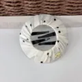 Detailed view of a chic white fabric hair clip featuring classic black polka dots and metal accent. - White Polka Dot