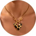 Close-up view of gold stainless steel chain with unique black drip oil heart pendant detail. - Black and White Spotted Heart Lock (C-61-1) / Gold Chain