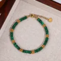Closeup of green malachite bead bracelet with gold metal spacer discs and heart steel tag. - Style 6 (S-01)