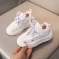 Close-up view of children's white casual sneakers with colorful laces and pink lining details. - Size 21 (Inner Length approx 13.5cm) / Pink