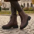Detailed view of brown lychee leather women's vintage Martin boots with thick soles. - 35 / Brown