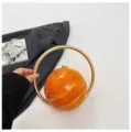 Spherical evening bag with gold ring handle, trendy marble pattern design for women. - Yellow