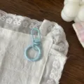 Light blue metal spring ring keychain DIY handmade craft accessories detailed close-up shot. - Blue
