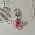 Pink butterfly keychain with floral pendant, cute transparent glitter bag accessory for gift. - Light Pink