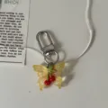 Transparent resin butterfly keychain with red cherry pendant, sweet style bag accessory gift. - Light Yellow