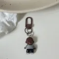 Cute funny Natasha baby doll keychain pendant, brown metal clasp bag charm accessory. - White Striped Clothes