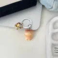 Cute standing cat keychain detail shot, featuring a resin figurine charm and a lovely bell. - Siamese Cat