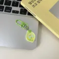 Cute green lemon cartoon keychain detail shot, premium resin fruit pendant with lobster clasp. - Lime