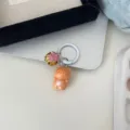 Detailed close-up of the cute cartoon cat keychain pendant featuring a mini bell ornament. - Orange Cat