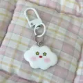Close-up detail of cute white cloud keychain with star eyes and blush pendant for bags and keys. - Star Eyes