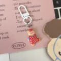 Cute cartoon bear keychain with red polka dot overalls, detailed bag pendant accessory. - Red Polka Dot Bear