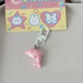 Cute pink dolphin keychain with white clasp and cartoon backing card, perfect gift. - Dolphin