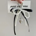 Pearl bowknot keychain detail, featuring chic black ribbon and silver heart charm for bags. - Black Bow - Heart Clasp