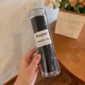 Black hair ties in clear cylinder, elastic hair bands for women daily styling and ponytails. - Black System