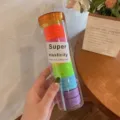 Colorful elastic hair ties in a transparent cylinder, assorted vibrant colors for styling. - Orange Series
