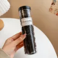 Black hair ties in a clear storage jar, 100 pieces pack variant for daily hairstyling. - Black Ribbed 100 Pcs