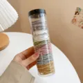 Colorful elastic hair ties in a clear storage jar, 200 pieces pack for daily hairstyles. - Gray Mixed Ribbed 200 Pcs