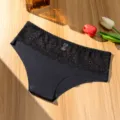 Lace low-waist briefs detail showcasing delicate floral waist pattern and soft black fabric. - S / Bottoms / Black