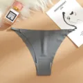 Detail view of seamless low-rise women panties with metal side adjusters on flat background. - Gray