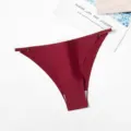 Detail view of the women's seamless ice silk thong featuring metal buckle and thin straps. - M / Bottoms / Burgundy