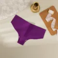 Detailed view of a solid purple seamless ice silk women underwear laid flat with elegant props. - XS / Bottoms / Purple