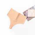 Detail view of women's seamless high-waist thong, minimalist solid soft invisible panty. - XS / Nude