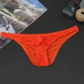 Men's breathable low-waist briefs detail view, showing smooth fabric and bright orange color. - Red