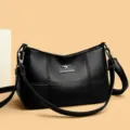 Schwarze Umhängetasche aus weichem Leder für Damen, geräumige Tasche mit klassischem Design. - Schwarz
