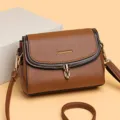 Detailansicht der stilvollen braunen Schultertasche aus Leder mit schicker Klappe und Metallverschluss. - Hellbraun