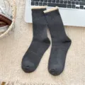 Women's dark grey crew socks featuring vintage ribbed knit and sweet lace ruffle trim. - Dark Gray