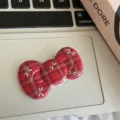 Detail view of a red plaid bow hair clip, featuring cute bow accents for daily styling. - Red Plaid Bow